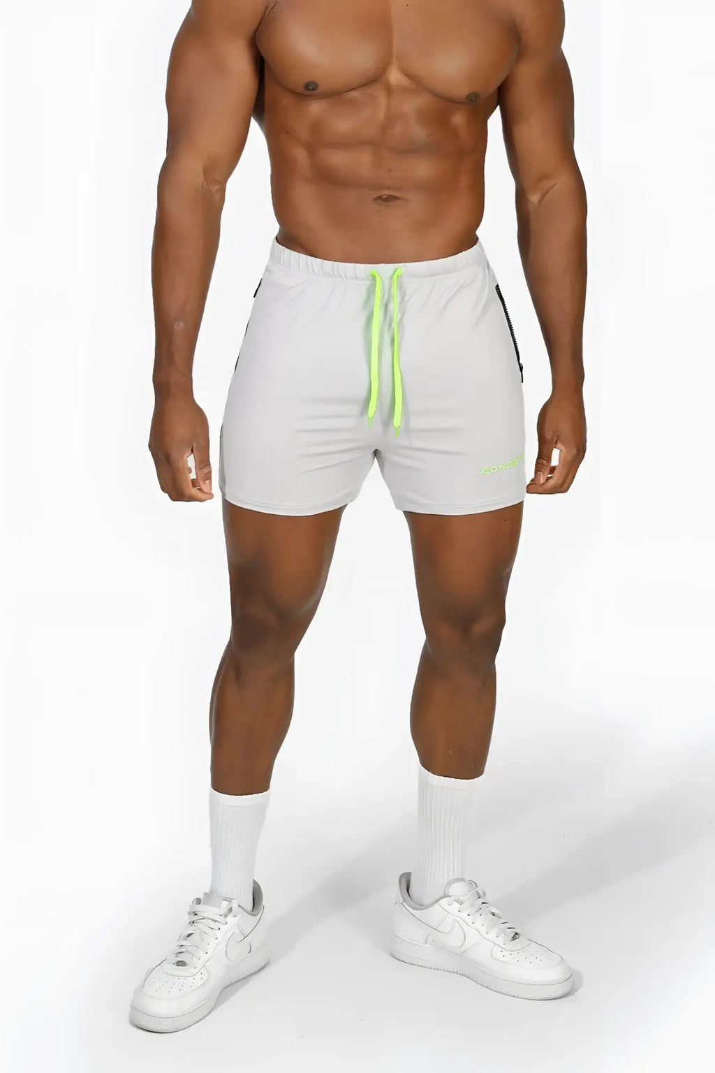 White jed north agile bodybuilding shorts with neon green drawstrings and black side panels for athletic use