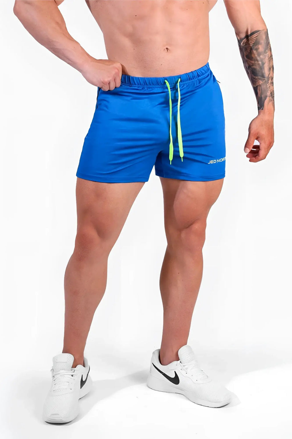 Jed North Agile bodybuilding shorts in royal blue with neon green drawstrings and zipper pockets for athletic use