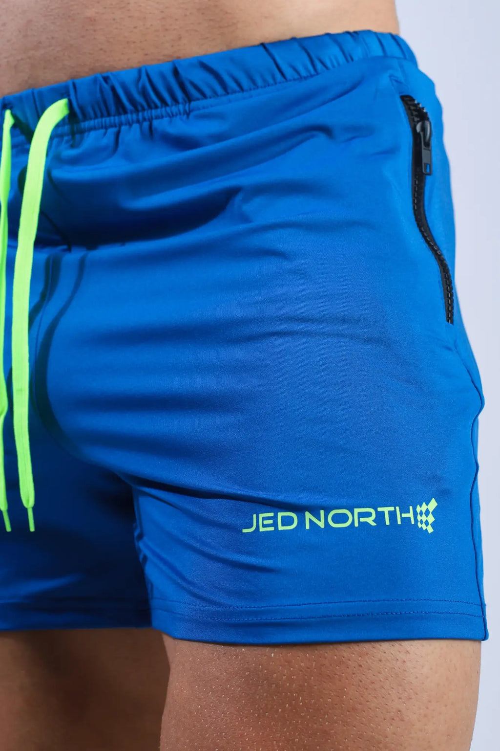 Jed north agile bodybuilding 4 inch royal blue shorts with neon green drawstrings zipper pockets and logo detail