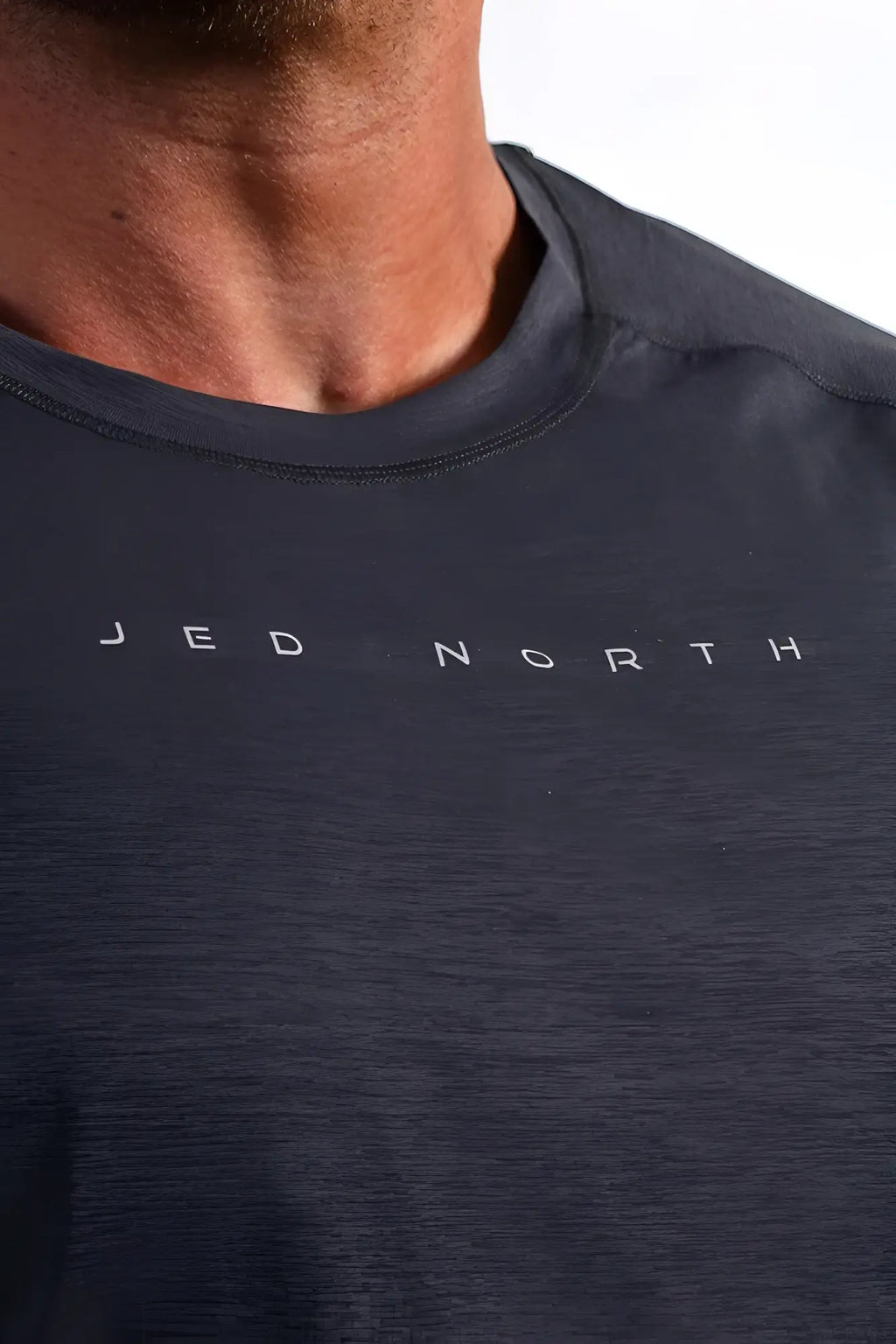 Dark gray heathered cotton long sleeve t-shirt with jed north printed in white for activewear training