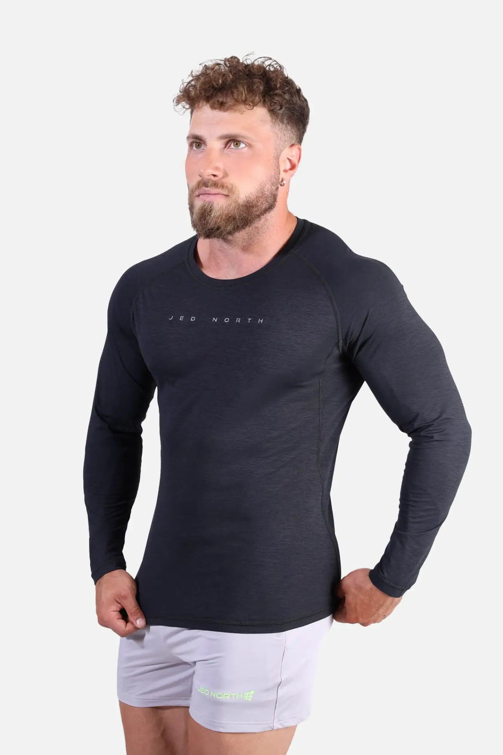 Jed North Agile long sleeve athletic shirt in charcoal black with subtle texture and branding across the chest
