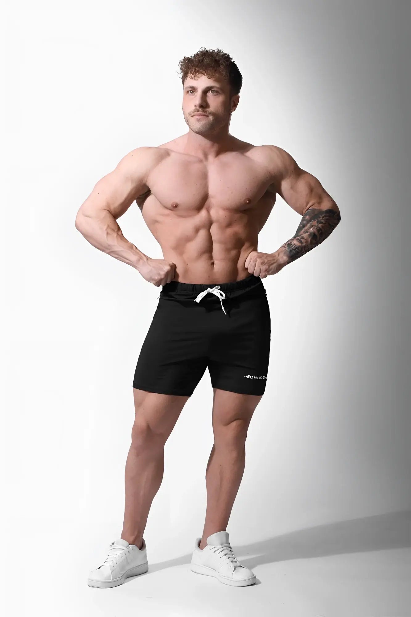 Jed North Agile Plus 6.5 inch black athletic shorts with white drawstring zipper pockets and subtle side logo