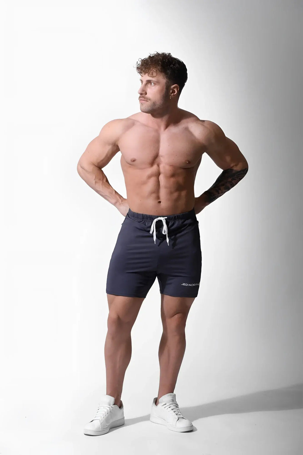 Navy blue jed north agile plus 65 inch bodybuilding shorts with white drawstring and subtle side branding