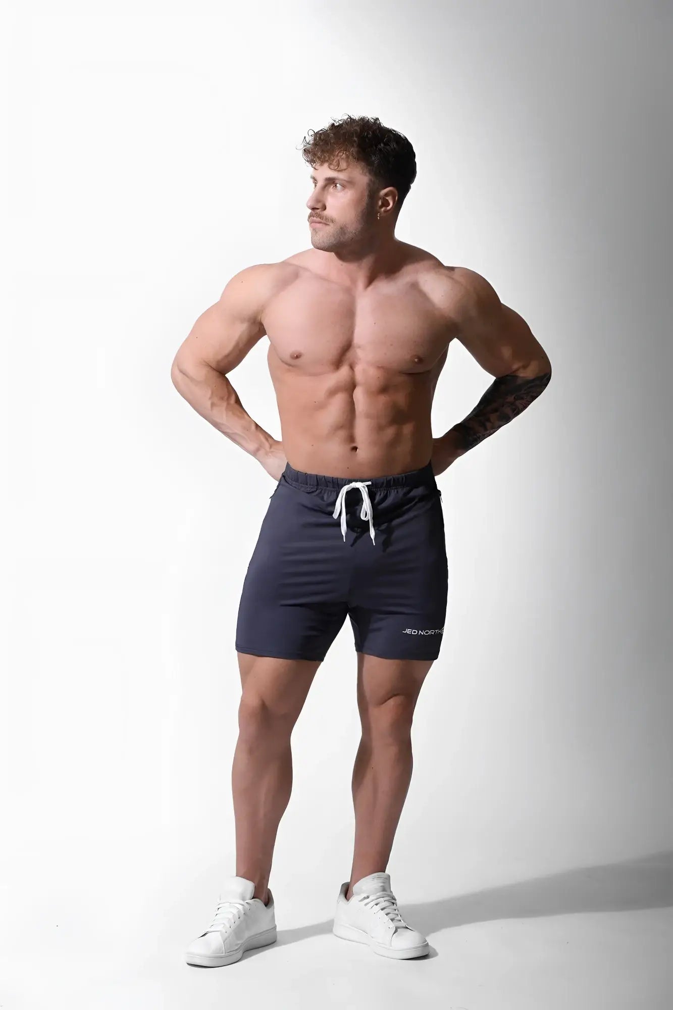 Navy blue jed north agile plus 65 inch bodybuilding shorts with white drawstring and subtle side branding