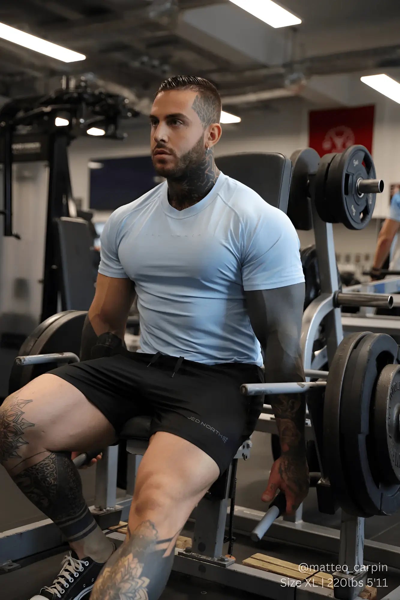 A man wearing a jed north agile short sleeve training tee in arctic blue with black branded athletic shorts