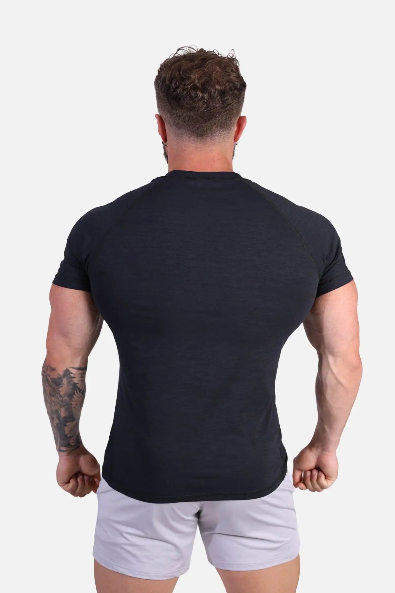 Black fitted short sleeve raglan sleeve t-shirt by Jed North designed for agile training in charcoal black color