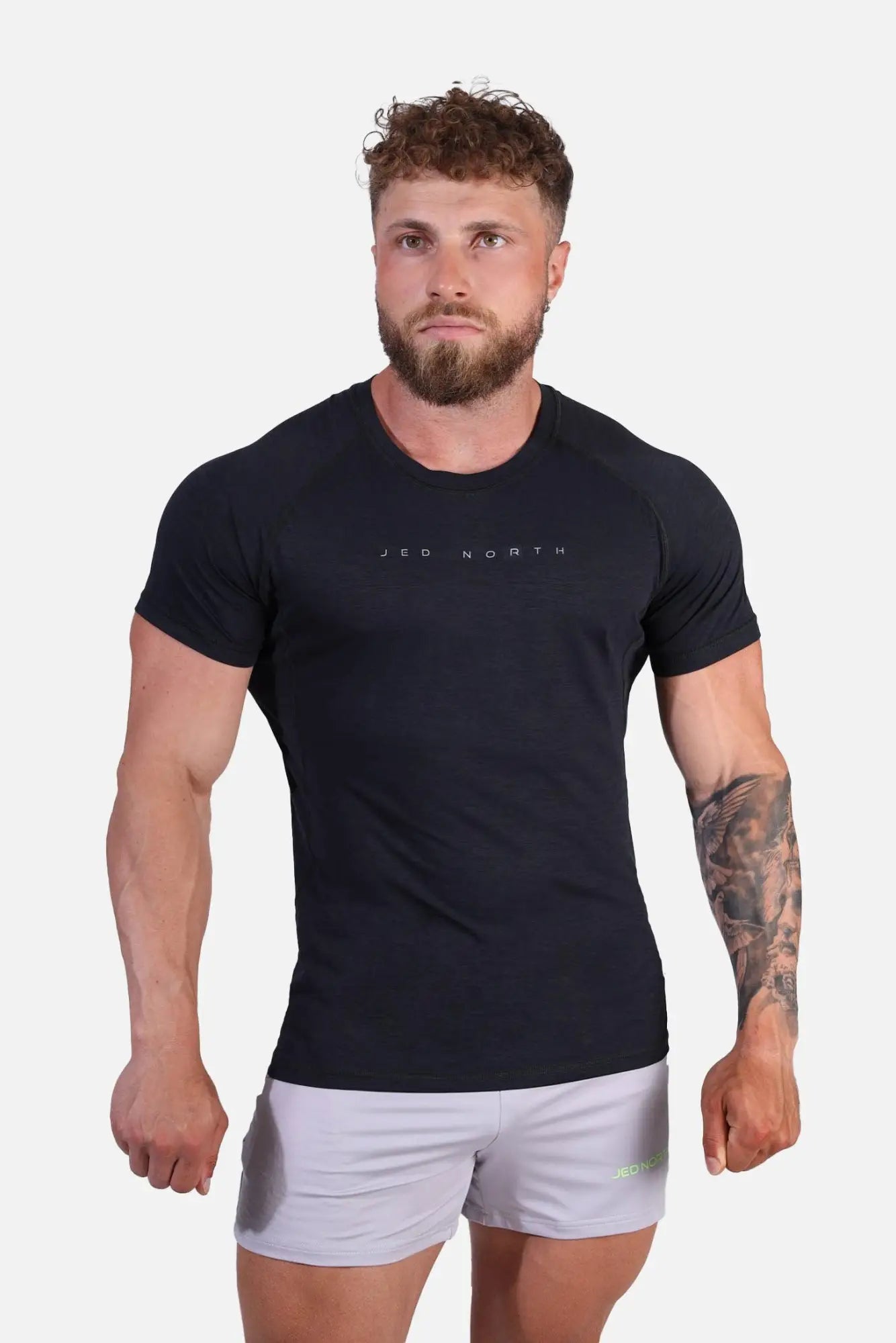 Black short-sleeved Jed North Agile training tee with subtle white leo north logo across the chest in charcoal black