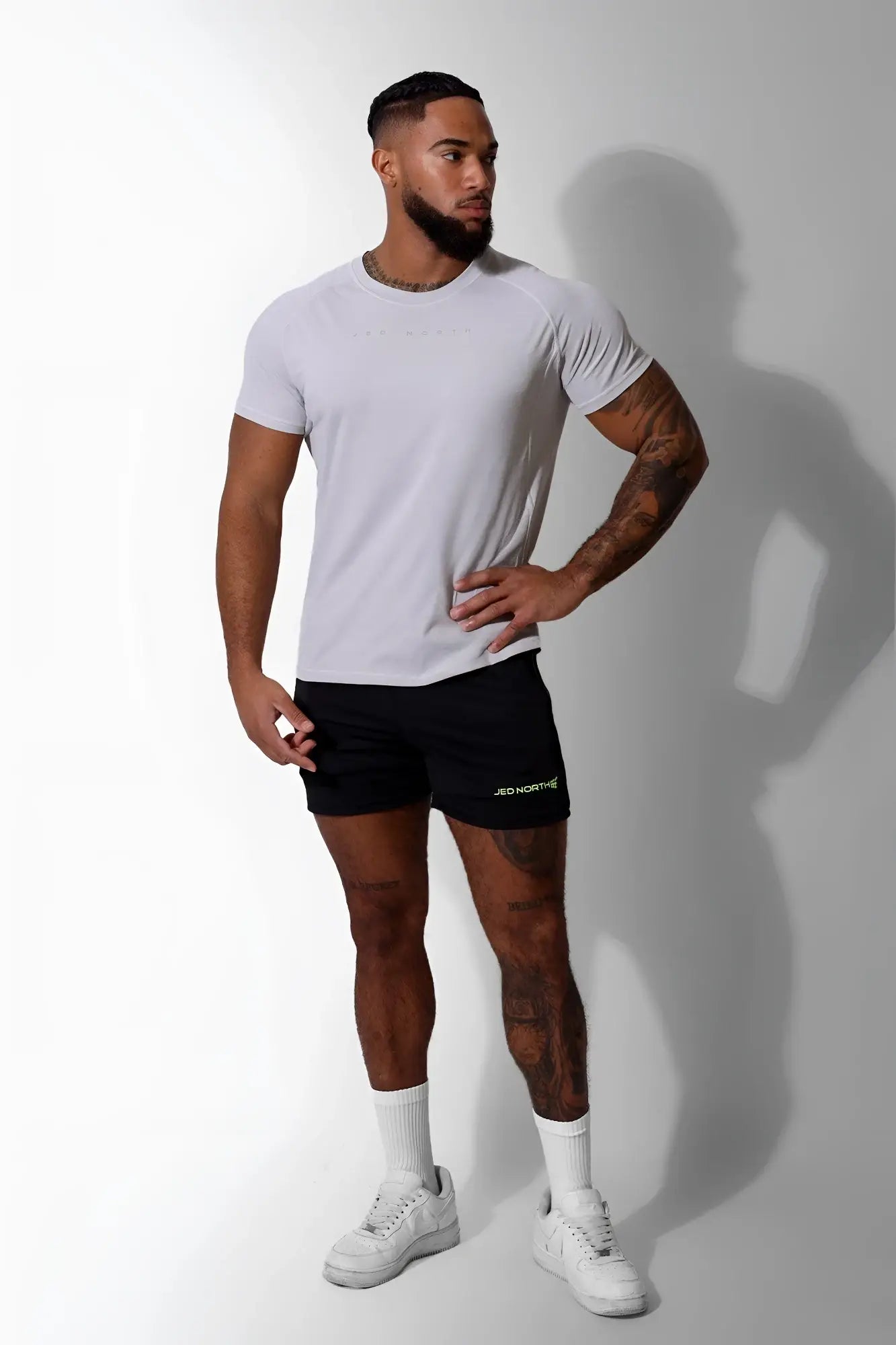 A man wearing a jed north agile short sleeve training tee in light gray with subtle chest branding and athletic fit