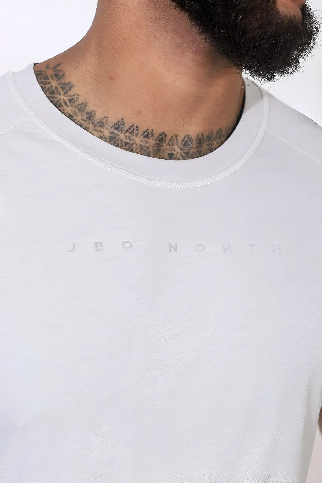 White crew-neck jed north agile short sleeve training tee in light gray with subtle logo lettering on chest