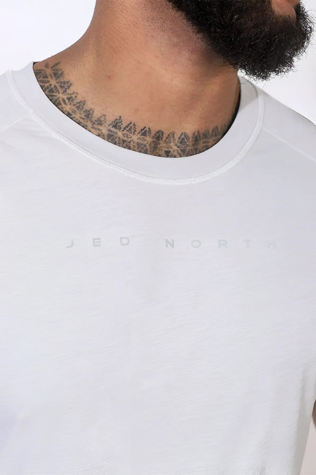 White crew-neck jed north agile short sleeve training tee in light gray with subtle logo lettering on chest