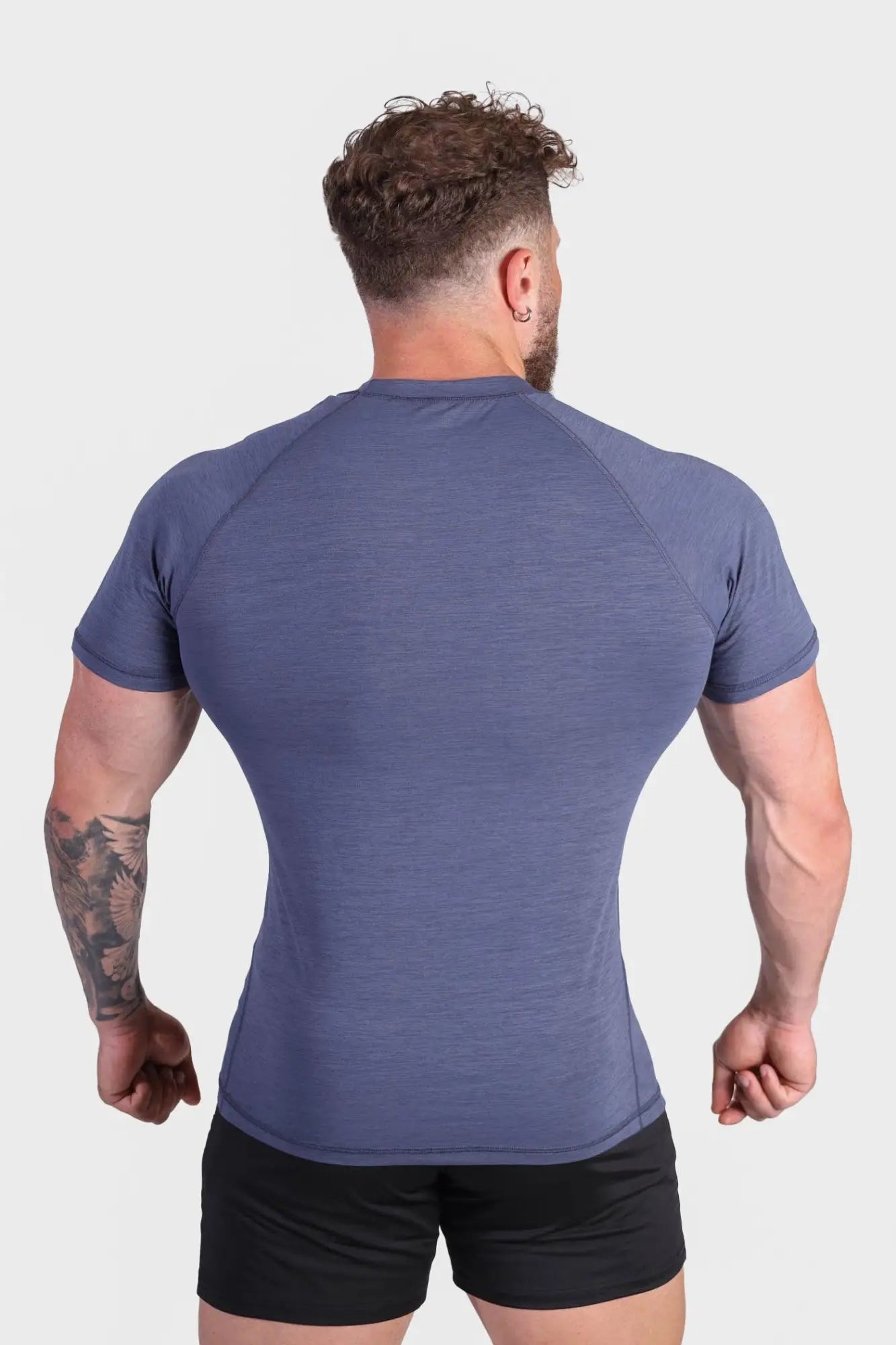 Agile short sleeve training tee in steel blue textured fabric designed for athletic performance and comfort