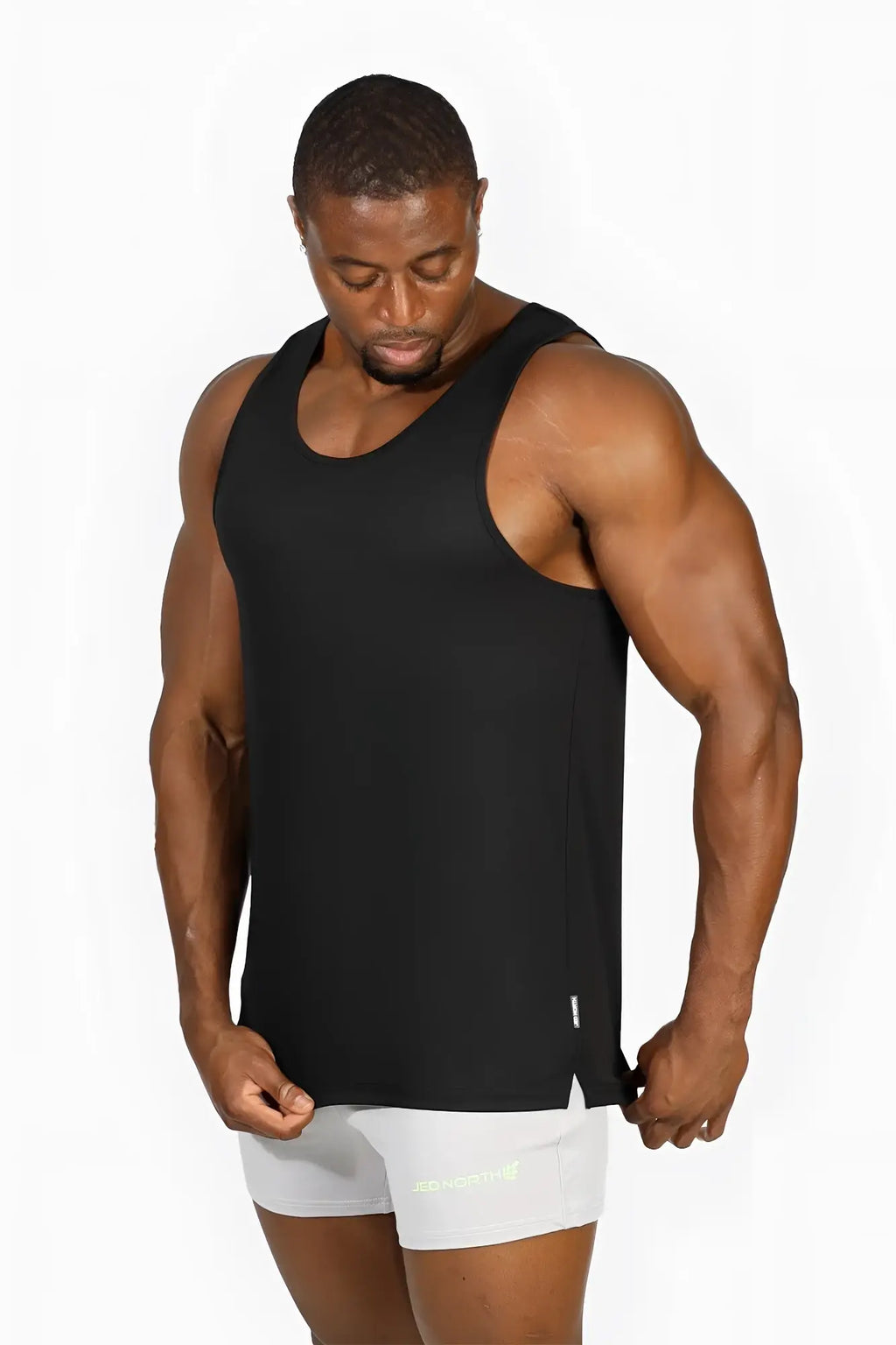 Black sleeveless jed north alpha microfiber fast dry gym tank top with subtle side slit and minimal branding detail