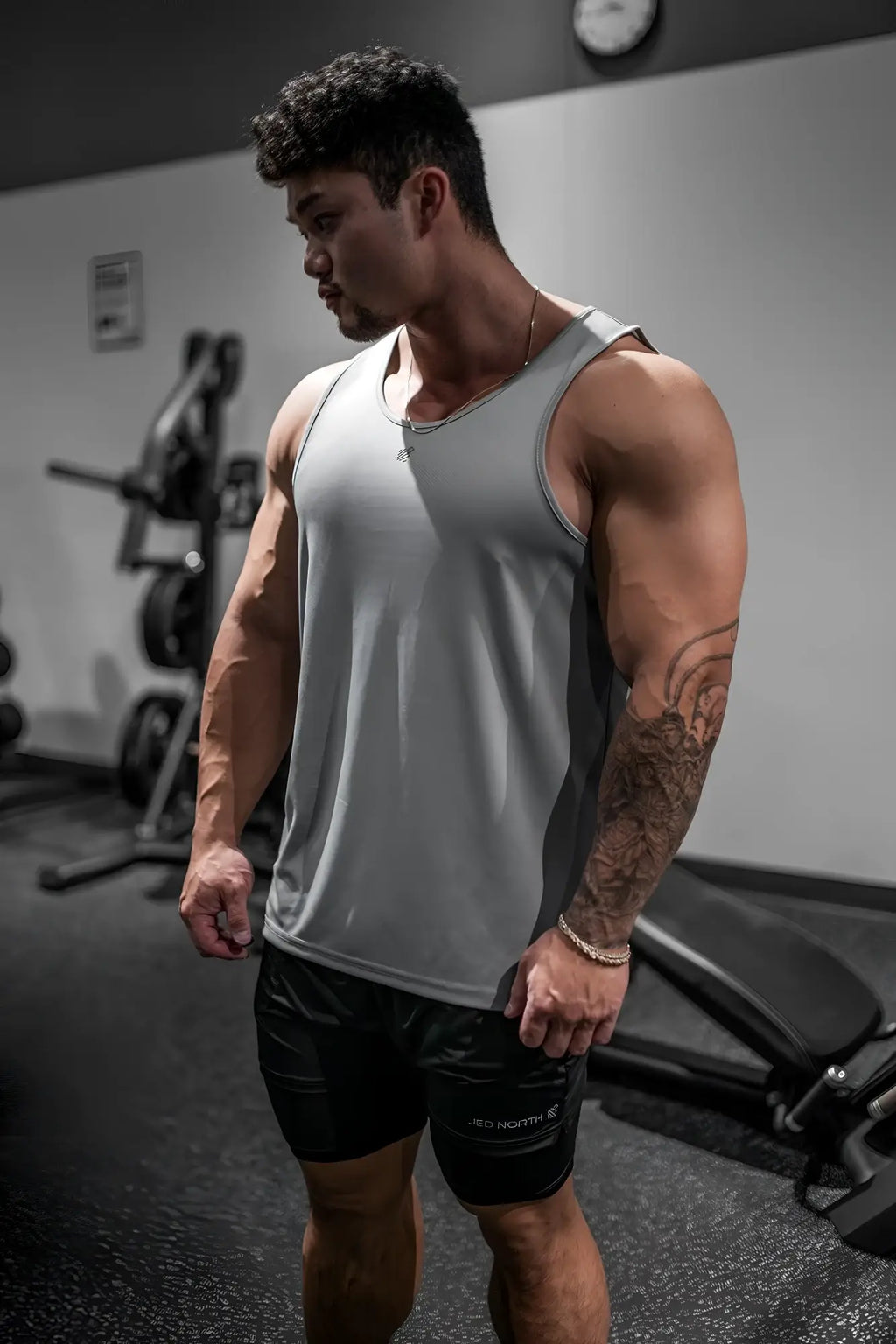 Gray adidas athletic tank top with subtle logo made of fast-dry microfiber for gym use in polar silver color