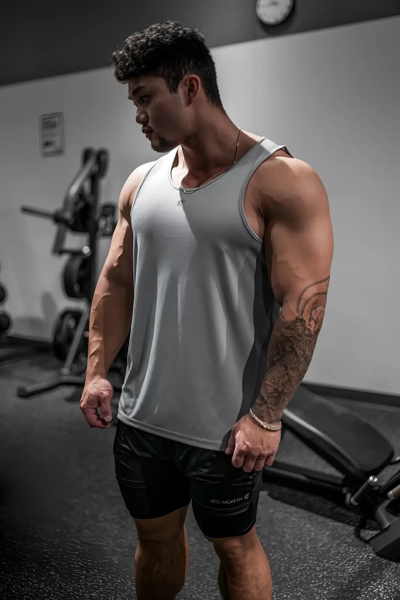 Gray adidas athletic tank top with subtle logo made of fast-dry microfiber for gym use in polar silver color