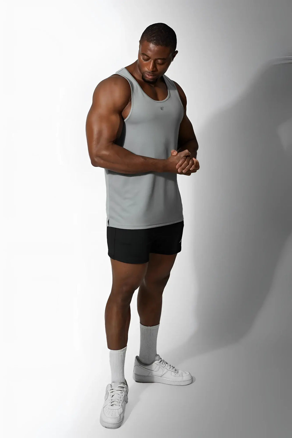 A sleek light gray Jed North Alpha microfiber fast-dry gym tank top with a subtle chest logo in polar silver