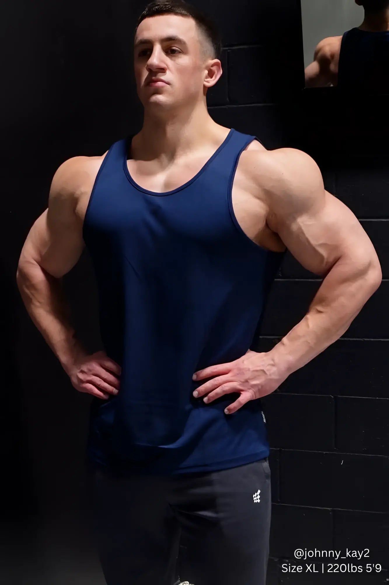 A navy blue sleeveless athletic tank top by Jed North with microfiber fast-dry fabric and a simple round neckline