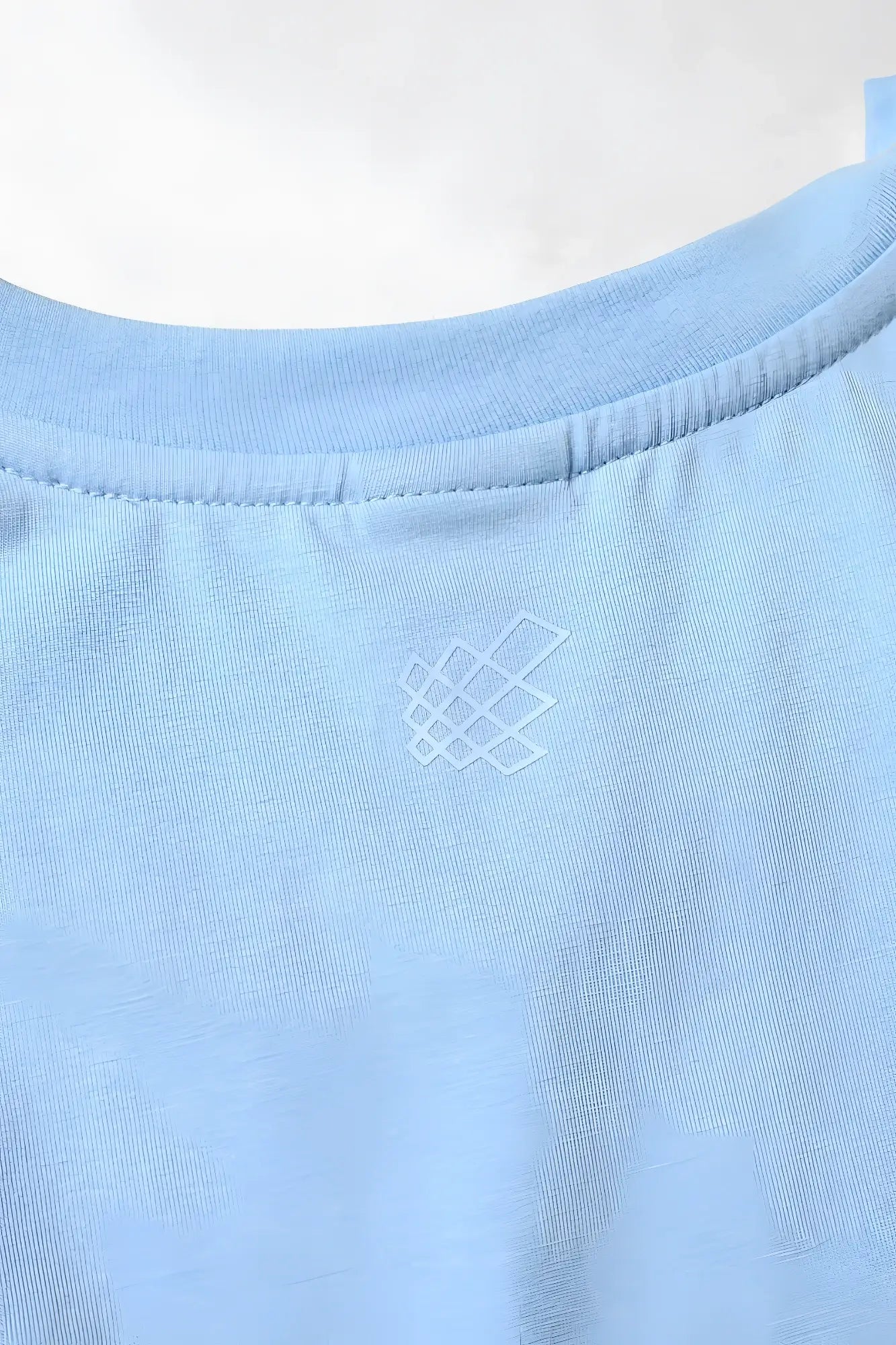 Apollo men’s sleeveless training tee in light blue cotton with a subtle white geometric logo embroidered near the neckline