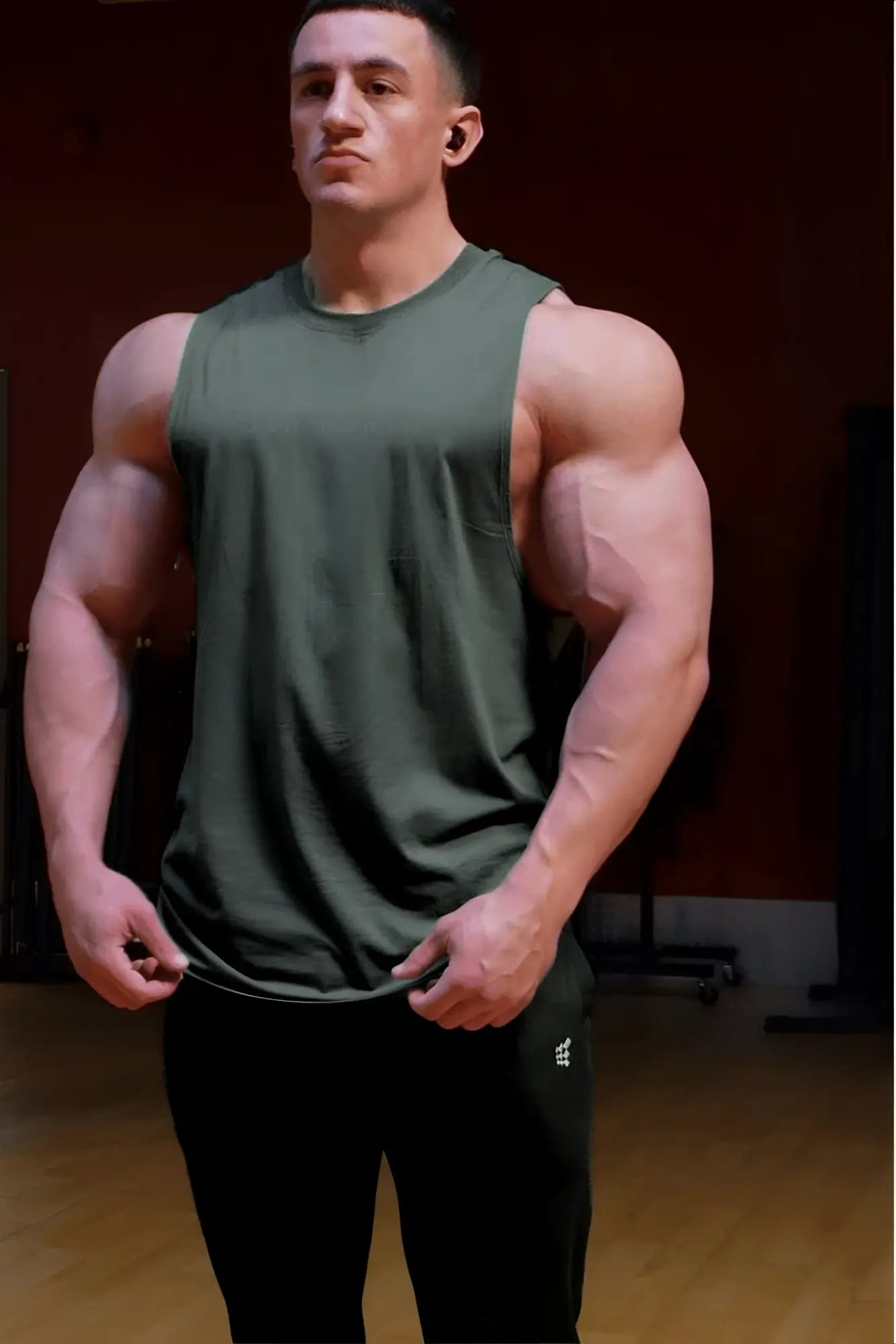 Apollo men’s sleeveless training tee in moss green olive with crew neckline and subtle side seam detail for athletic use