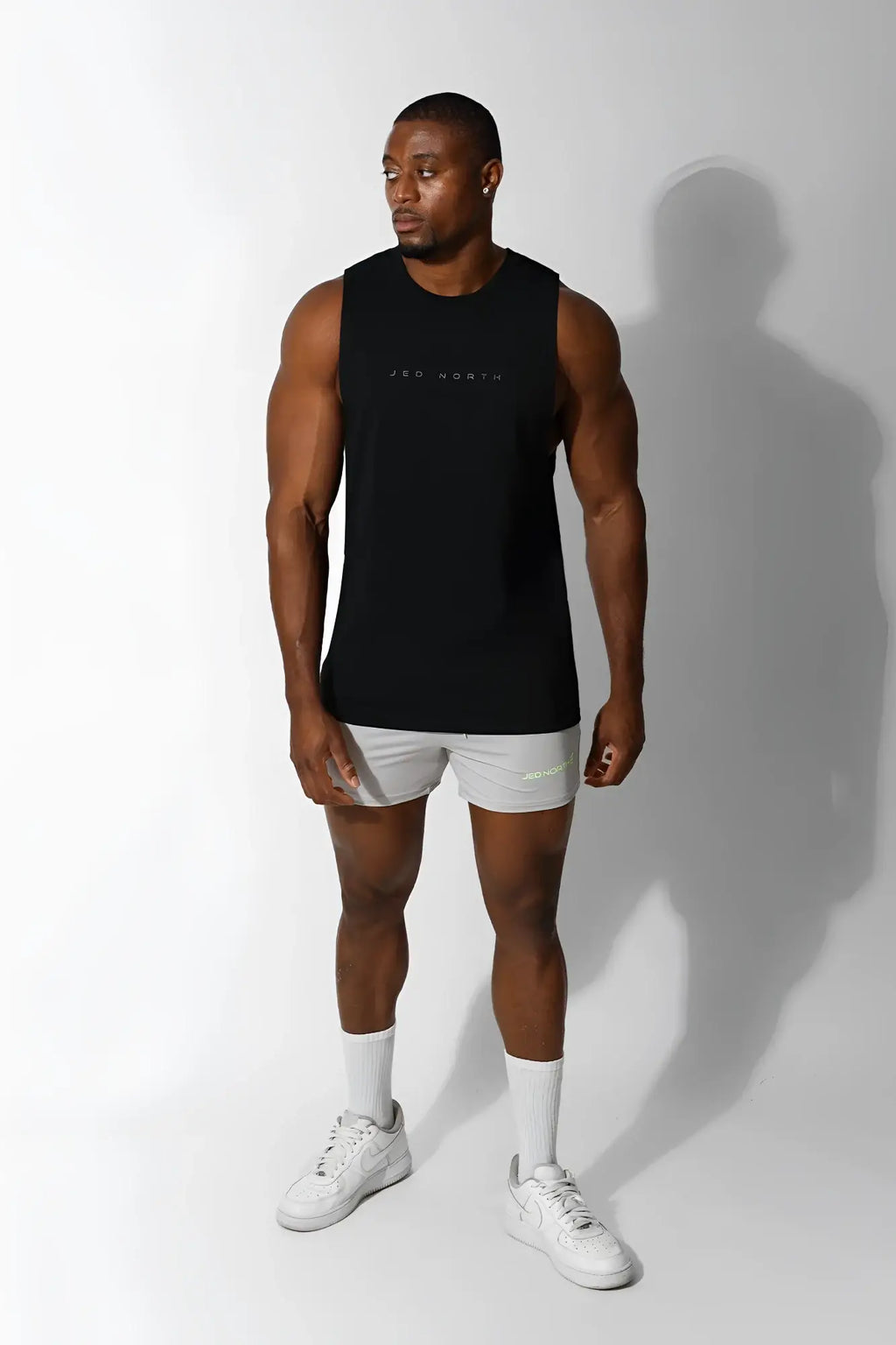 Jed North Apollo men’s sleeveless training tee in obsidian black muscle tank top with subtle white lettering across chest