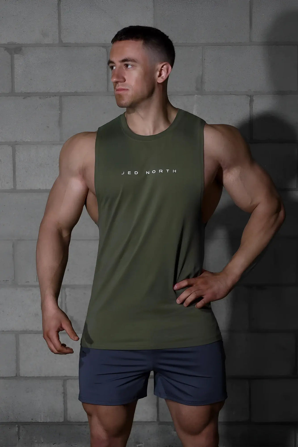 Olive green sleeveless athletic tank top with jed north logo in white designed for training and workouts