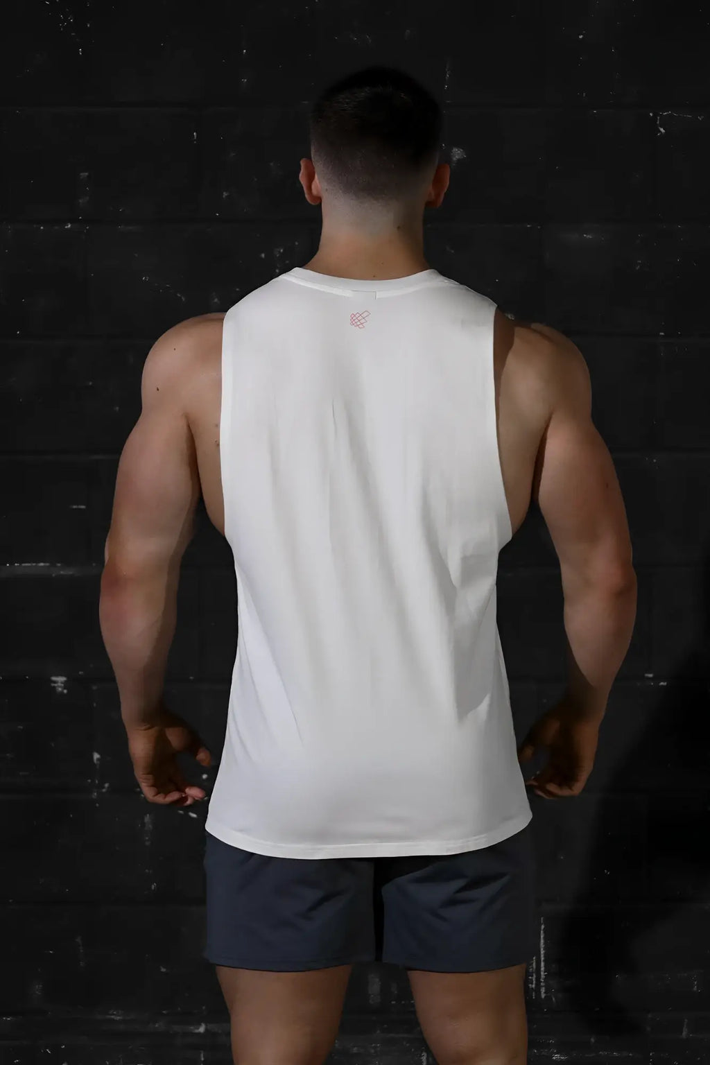 Jed north apollo men’s white sleeveless training tee with subtle pink logo at neckline perfect for workouts