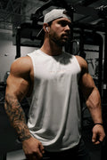 White sleeveless athletic tank top with subtle pink lettering across the chest from jed north apollo mens training tee