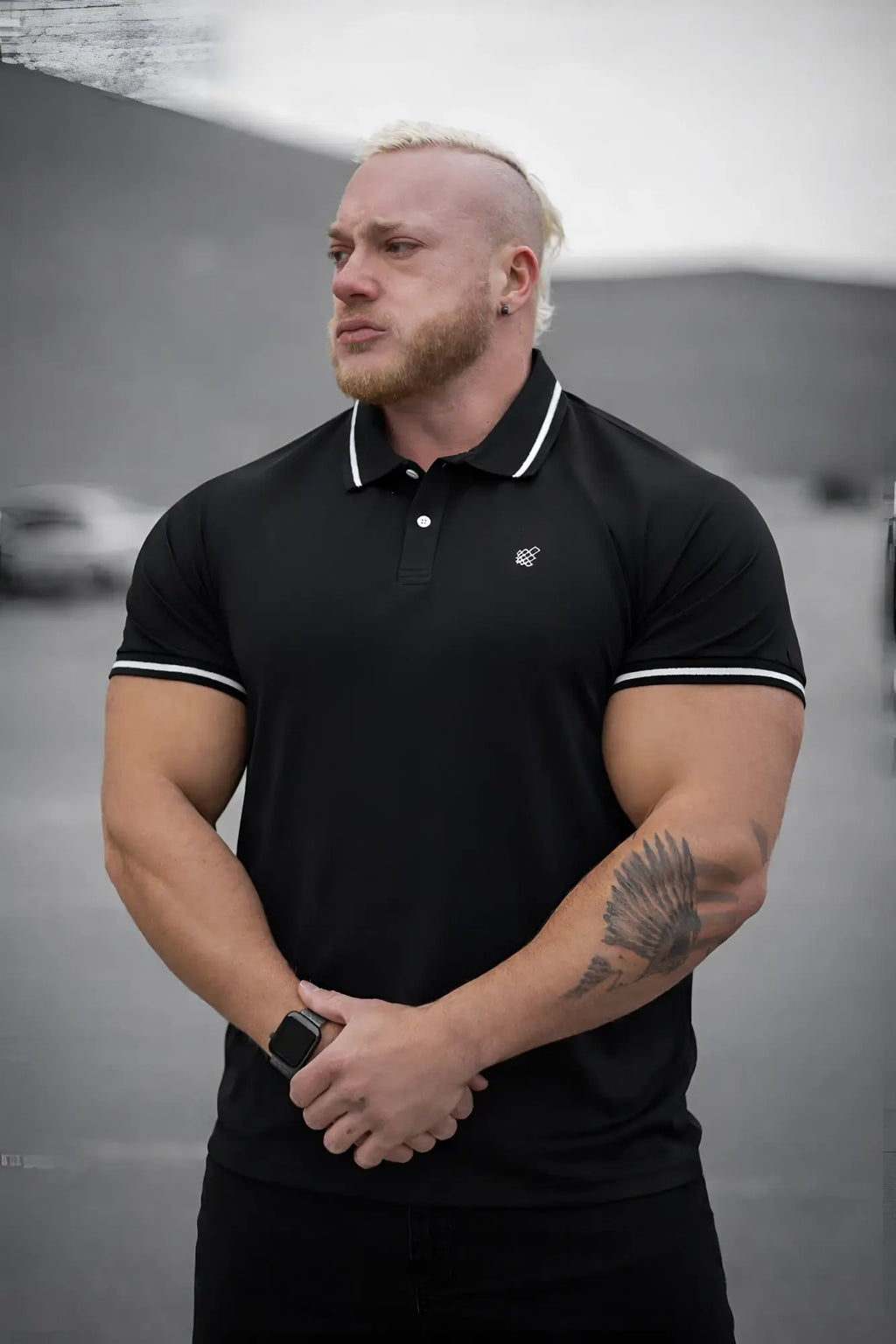 Black banded muscle-fit polo t-shirt with white trim on collar and sleeve cuffs made from breathable fabric