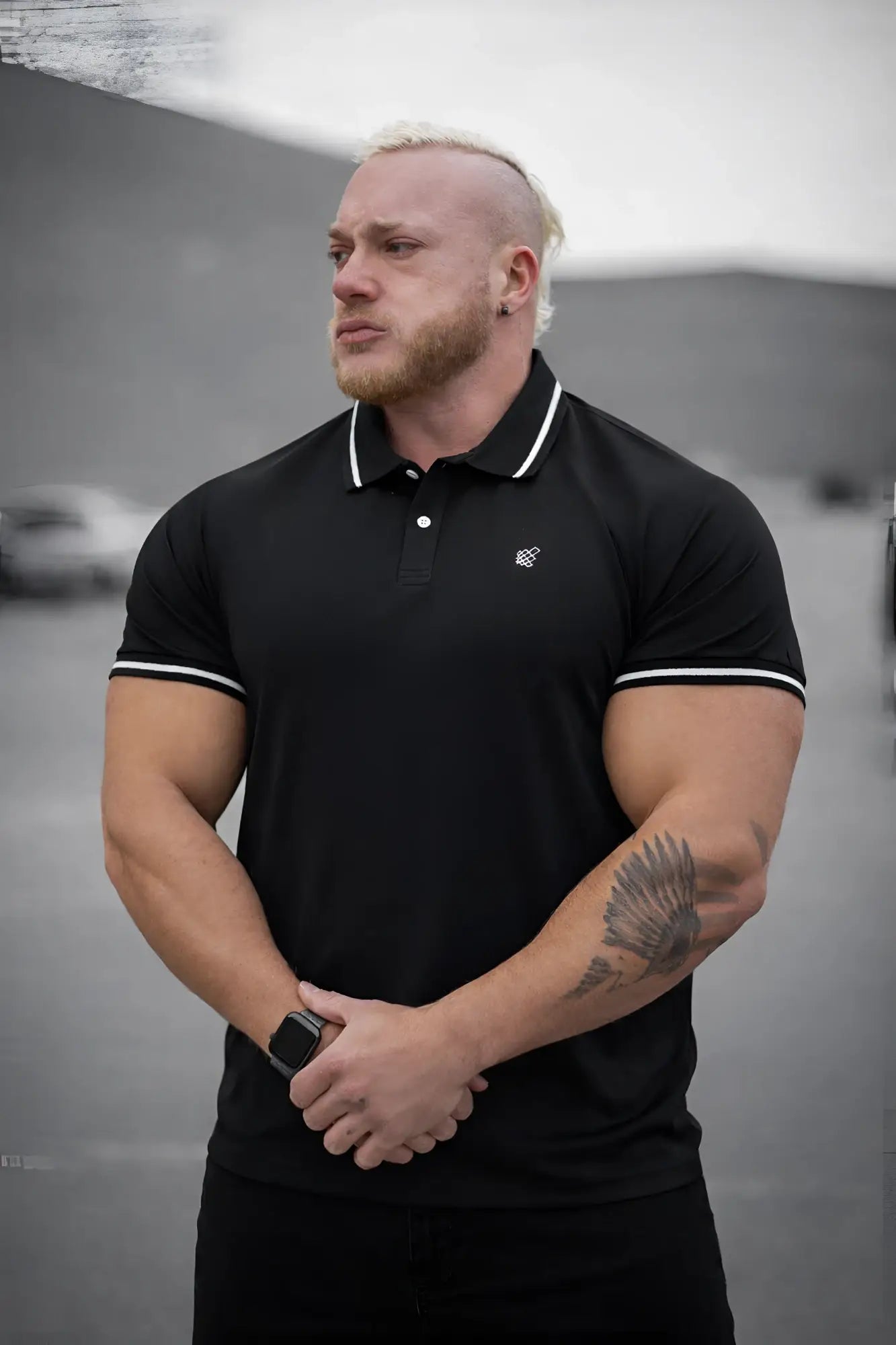 Black banded muscle-fit polo t-shirt with white trim on collar and sleeve cuffs made from breathable fabric