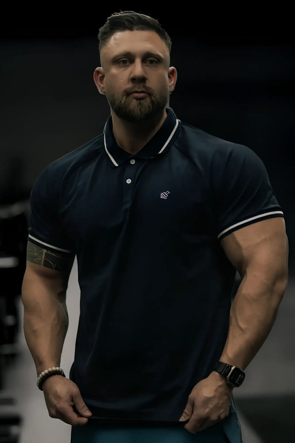 Dark navy blue banded muscle-fit polo shirt with white trim on collar and sleeve cuffs for casual wear