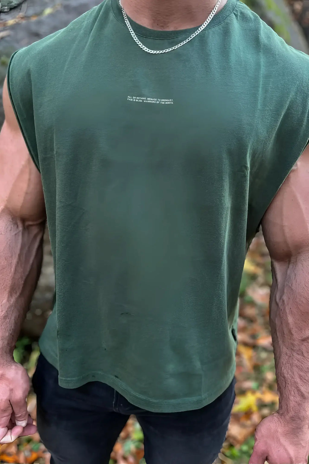 Dark green sleeveless cotton box cut muscle tee with small white text print across the chest forest green