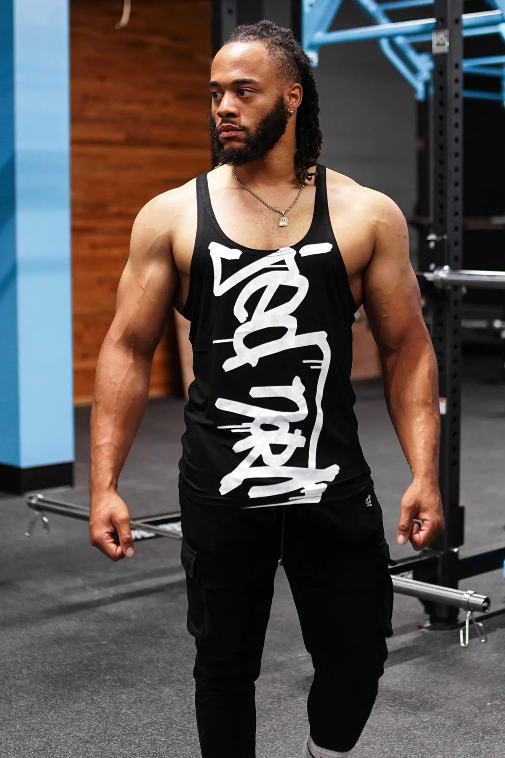 Classic bodybuilding racerback stringer black tank top with bold white stylized logo lettering across the front