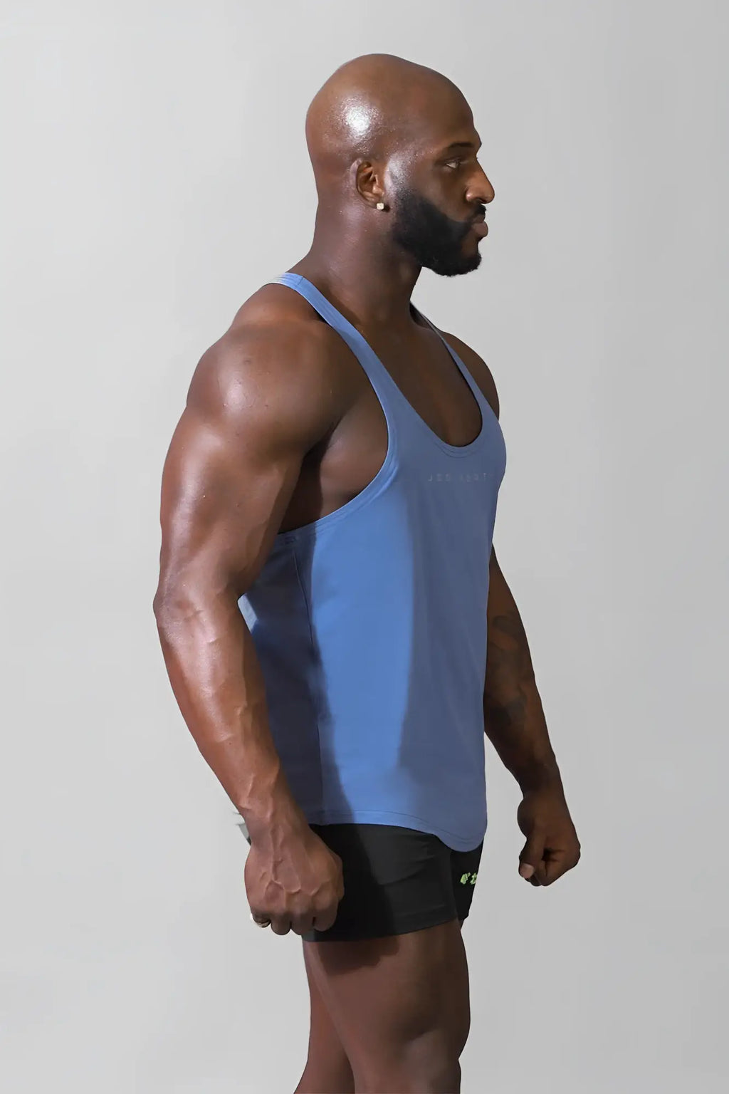 A sleek light blue jed north classic bodybuilding racerback stringer tank top with subtle chest branding