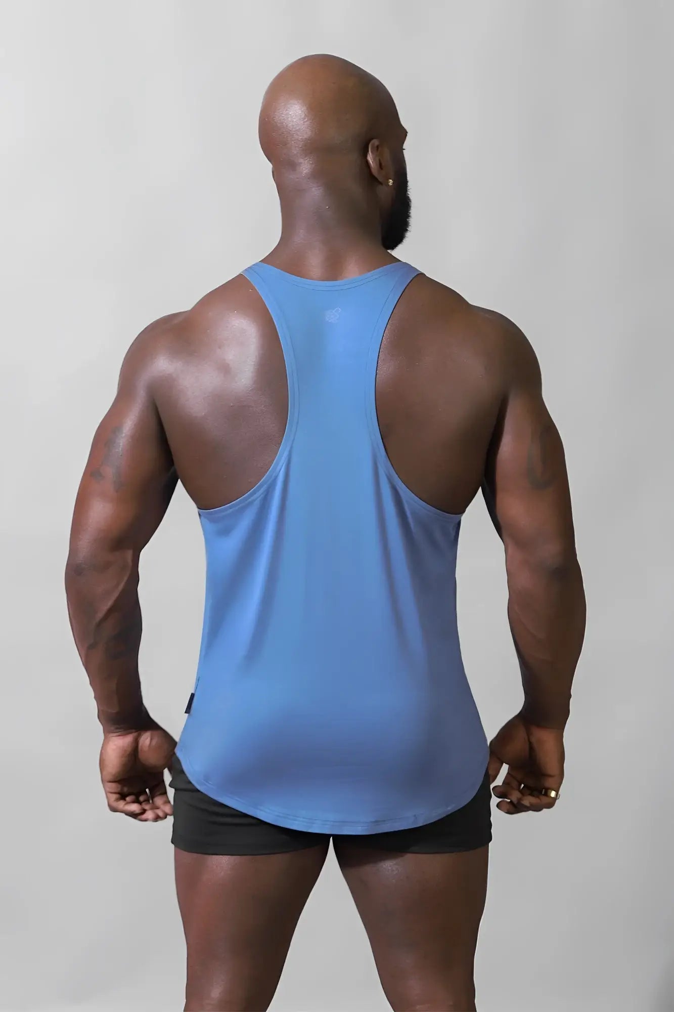 A sleek light blue jed north classic bodybuilding racerback stringer with smooth fabric finish