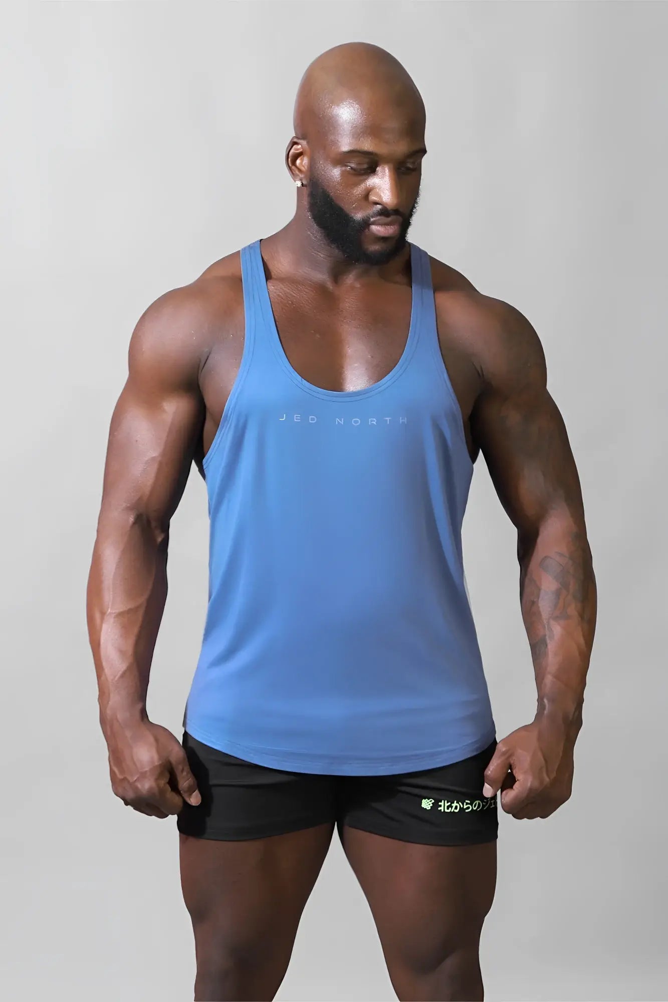 Blue jed north classic bodybuilding racerback stringer tank top with subtle jed north logo across the chest
