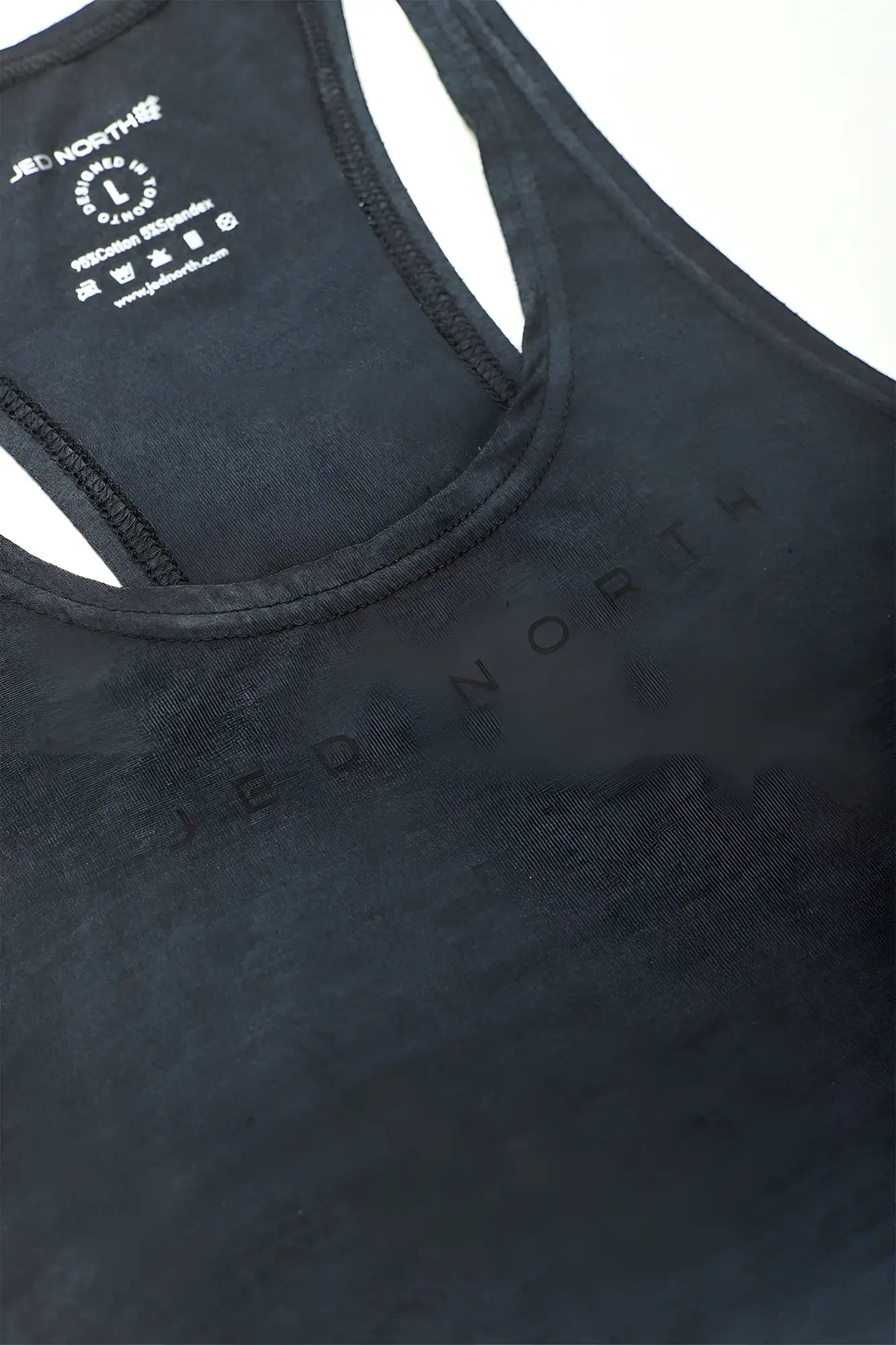 Black north racerback tank top with subtle tonal branding across the chest in a classic bodybuilding stringer style