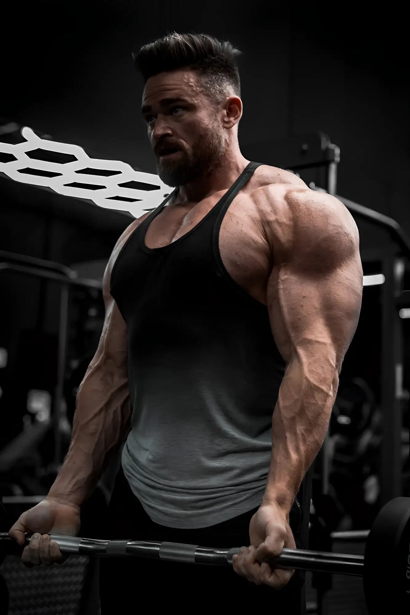 Muscular man lifting weights wearing a gray ombre classic bodybuilding racerback stringer tank top in the gym