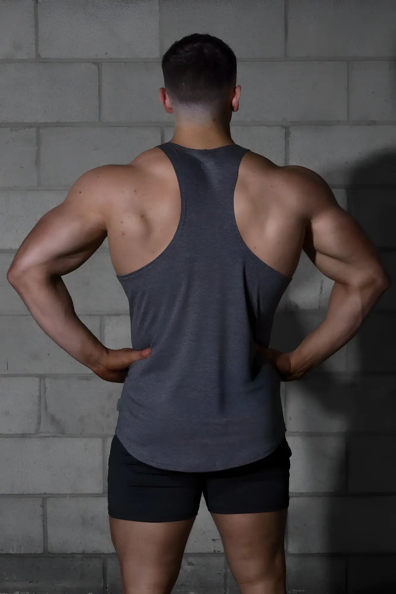 A dark gray heather gray jed north classic bodybuilding racerback stringer muscle tank top with a sleeveless design