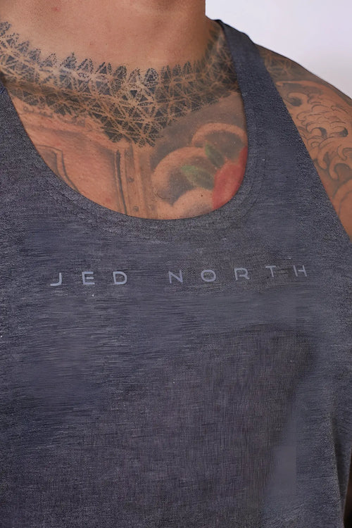 A dark heather gray jed north classic bodybuilding racerback stringer tank top with a subtle logo on the chest