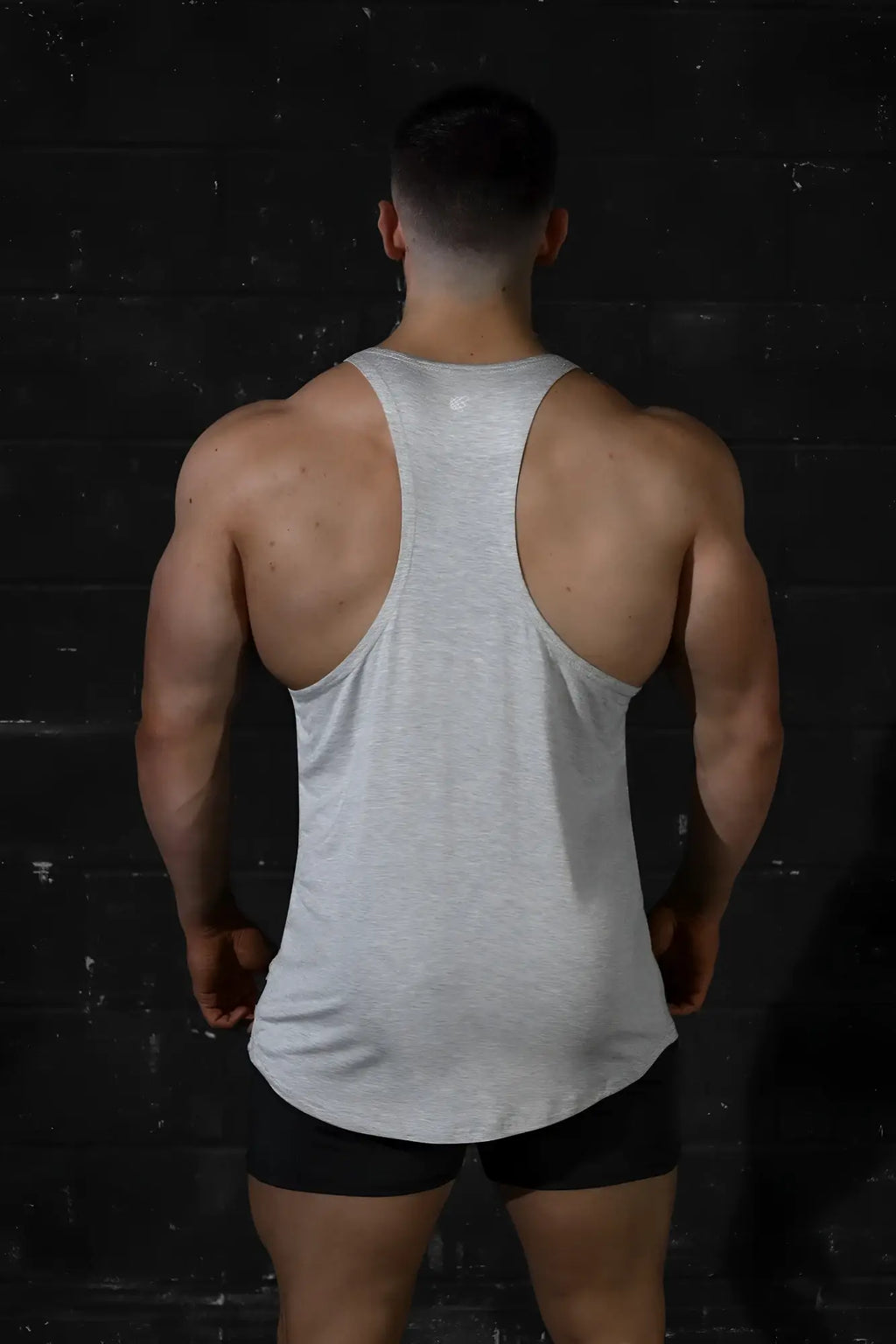 Back view of jed north classic bodybuilding racerback stringer in light gray heather with textured fabric and small logo