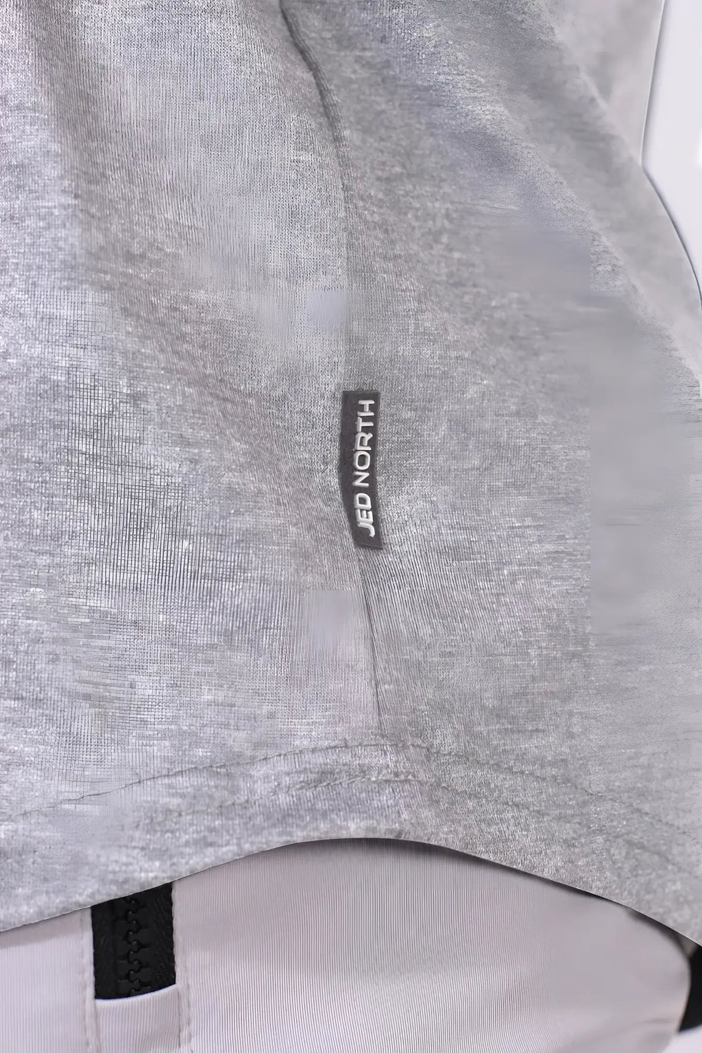 Gray heathered fabric with black jed north label on the seam of the classic bodybuilding racerback stringer light gray