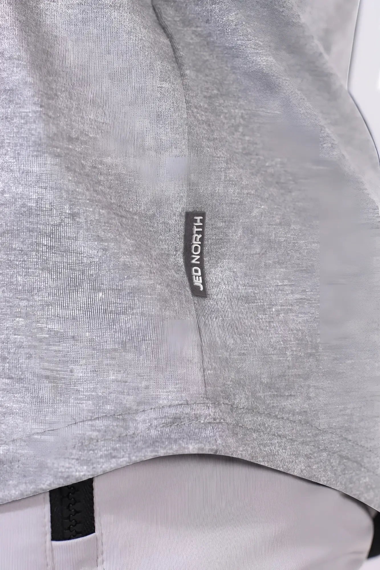 Gray heathered fabric with black jed north label on the seam of the classic bodybuilding racerback stringer light gray