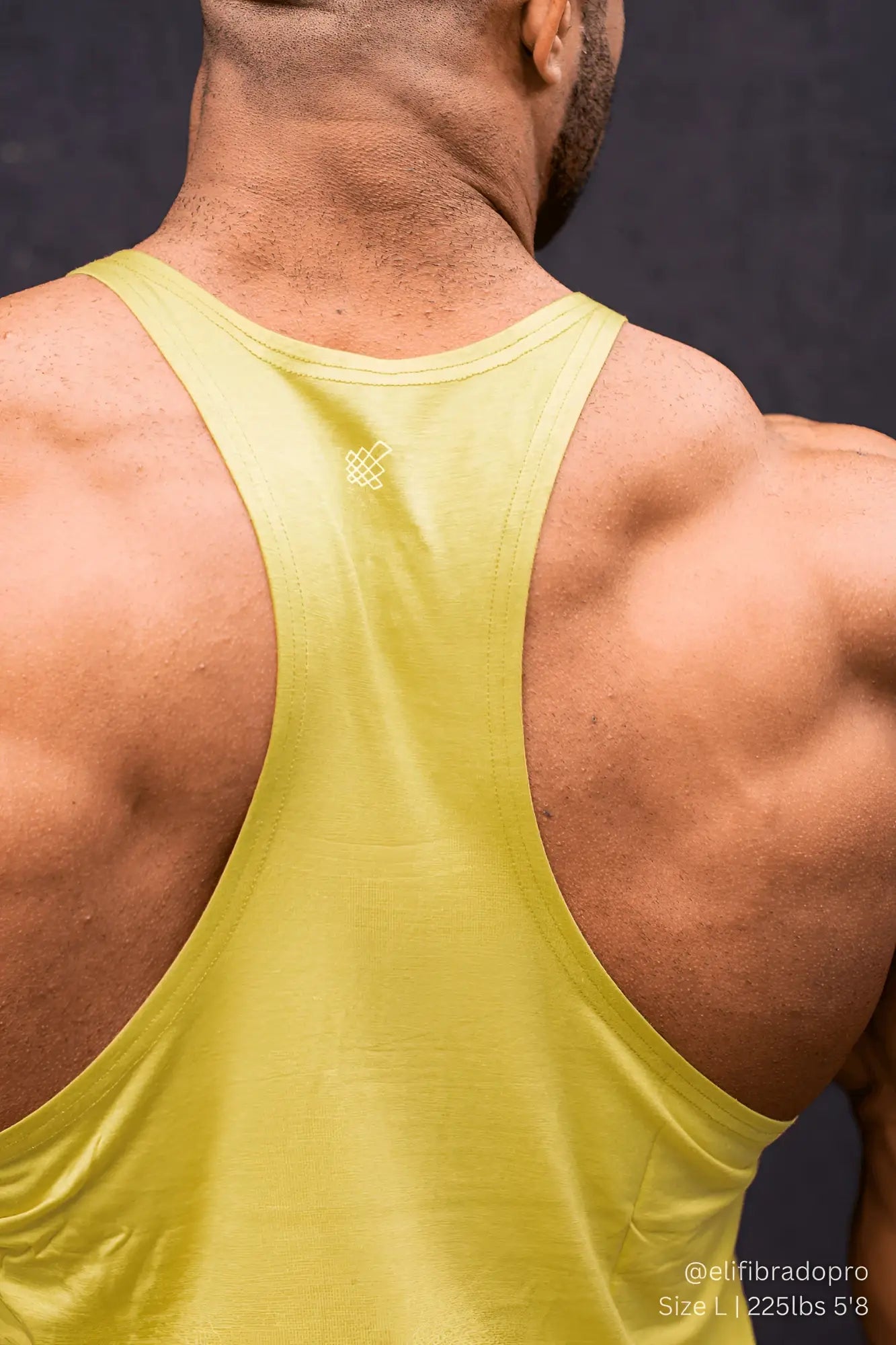 Back view of a jed north classic bodybuilding racerback stringer in vibrant lime green with a subtle white logo