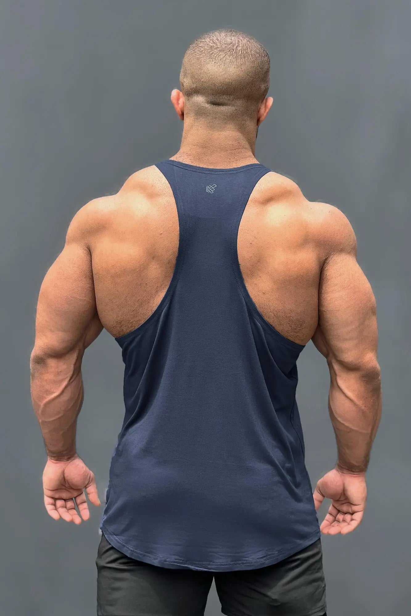 Back view of a navy jed north classic bodybuilding racerback stringer muscle tank top with a small logo on upper back