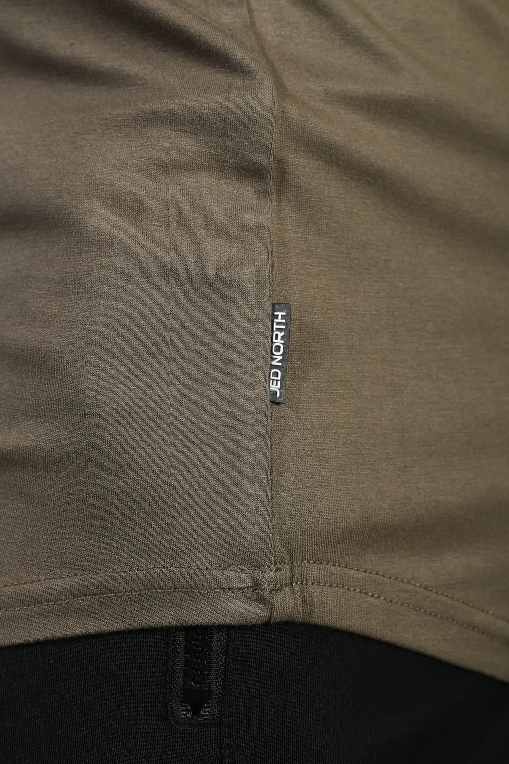 Olive green cotton jed north classic bodybuilding racerback stringer t-shirt with black brand tag near hem