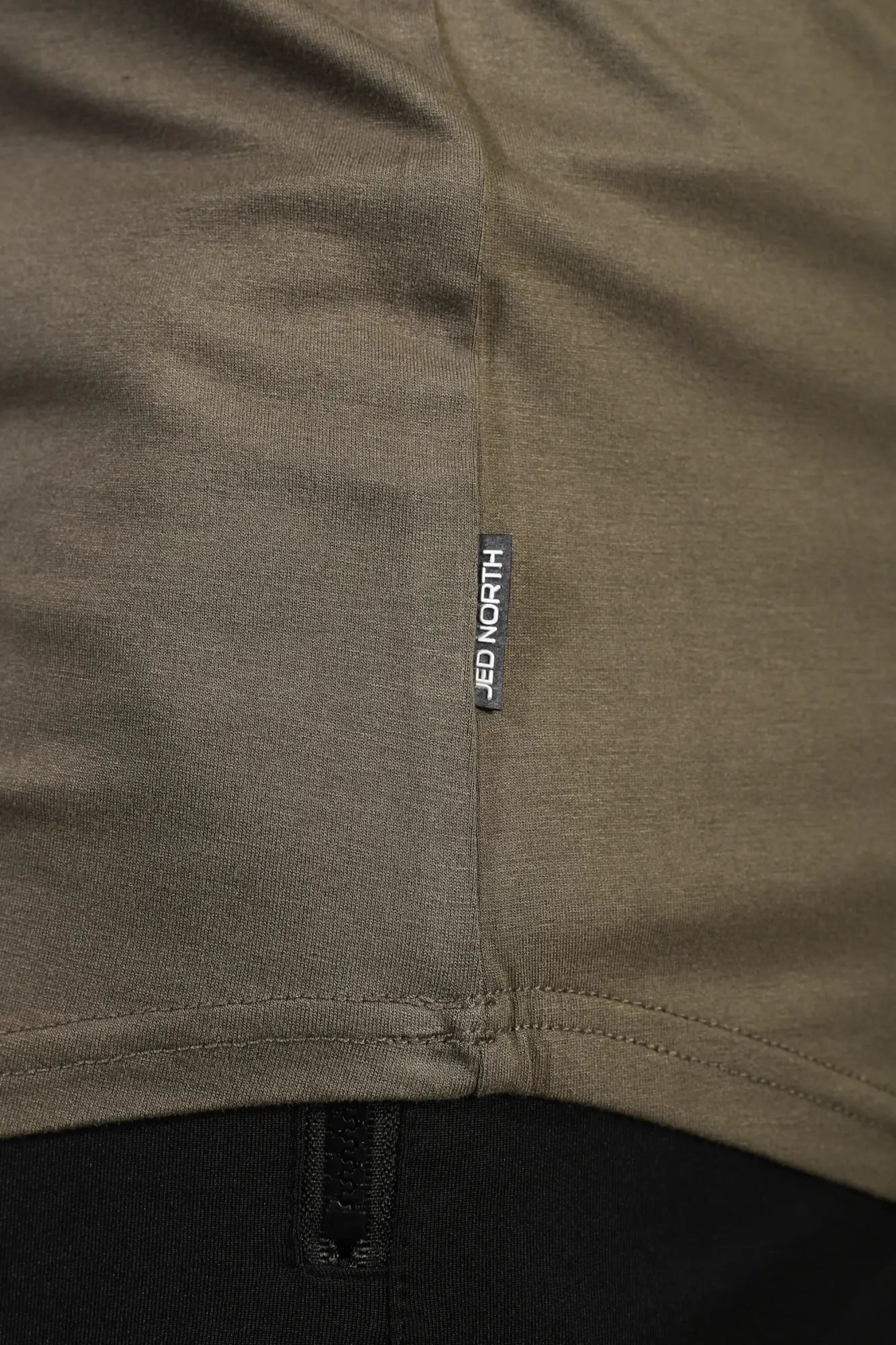 Olive green cotton jed north classic bodybuilding racerback stringer t-shirt with black brand tag near hem