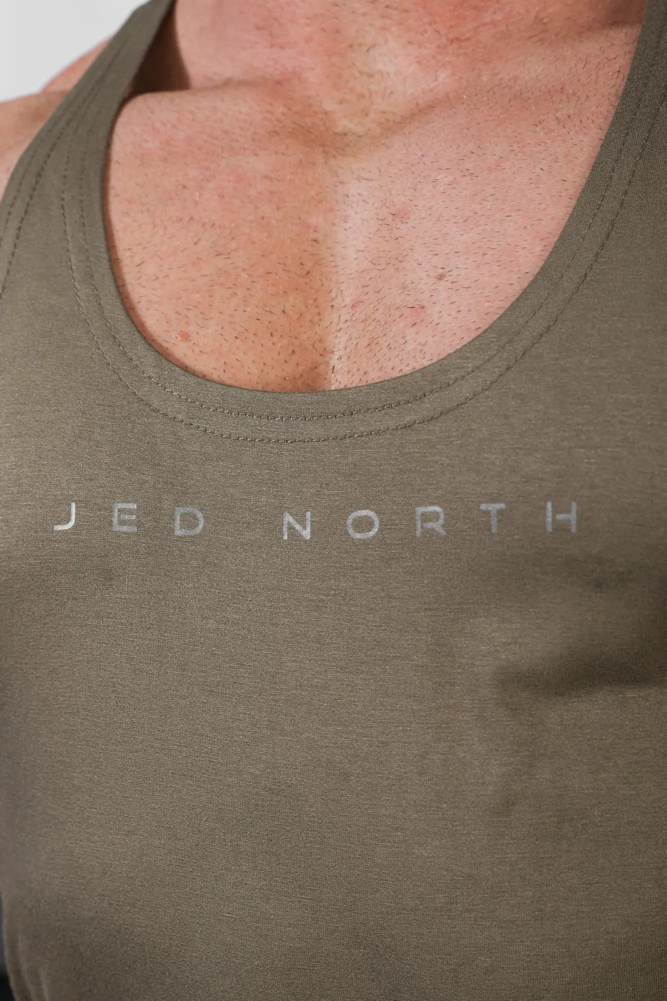 Olive green cotton tank top with jed north printed in silver across the chest classic bodybuilding racerback stringer
