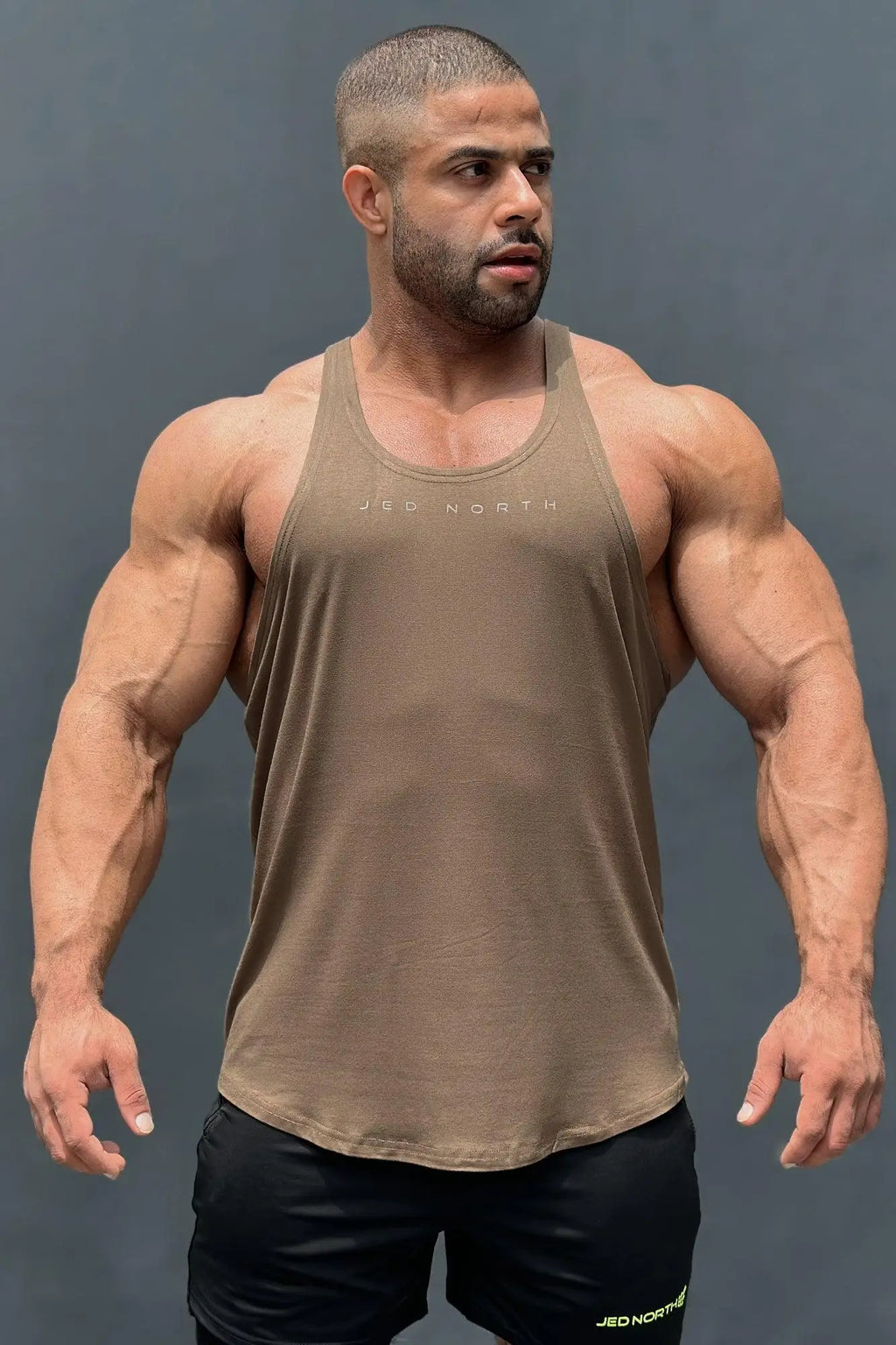 Tan sleeveless tank top with subtle jed north logo across chest from jed north classic bodybuilding racerback stringer olive