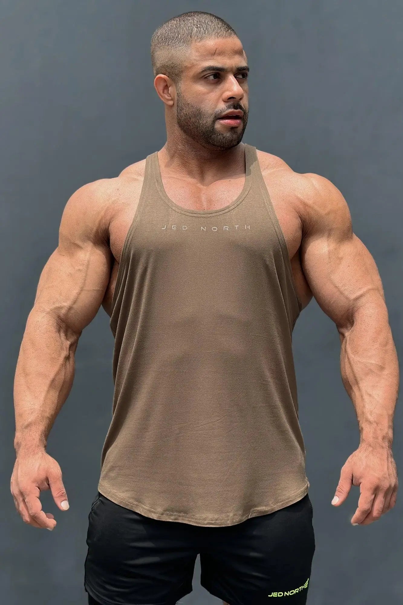 Tan sleeveless tank top with subtle jed north logo across chest from jed north classic bodybuilding racerback stringer olive