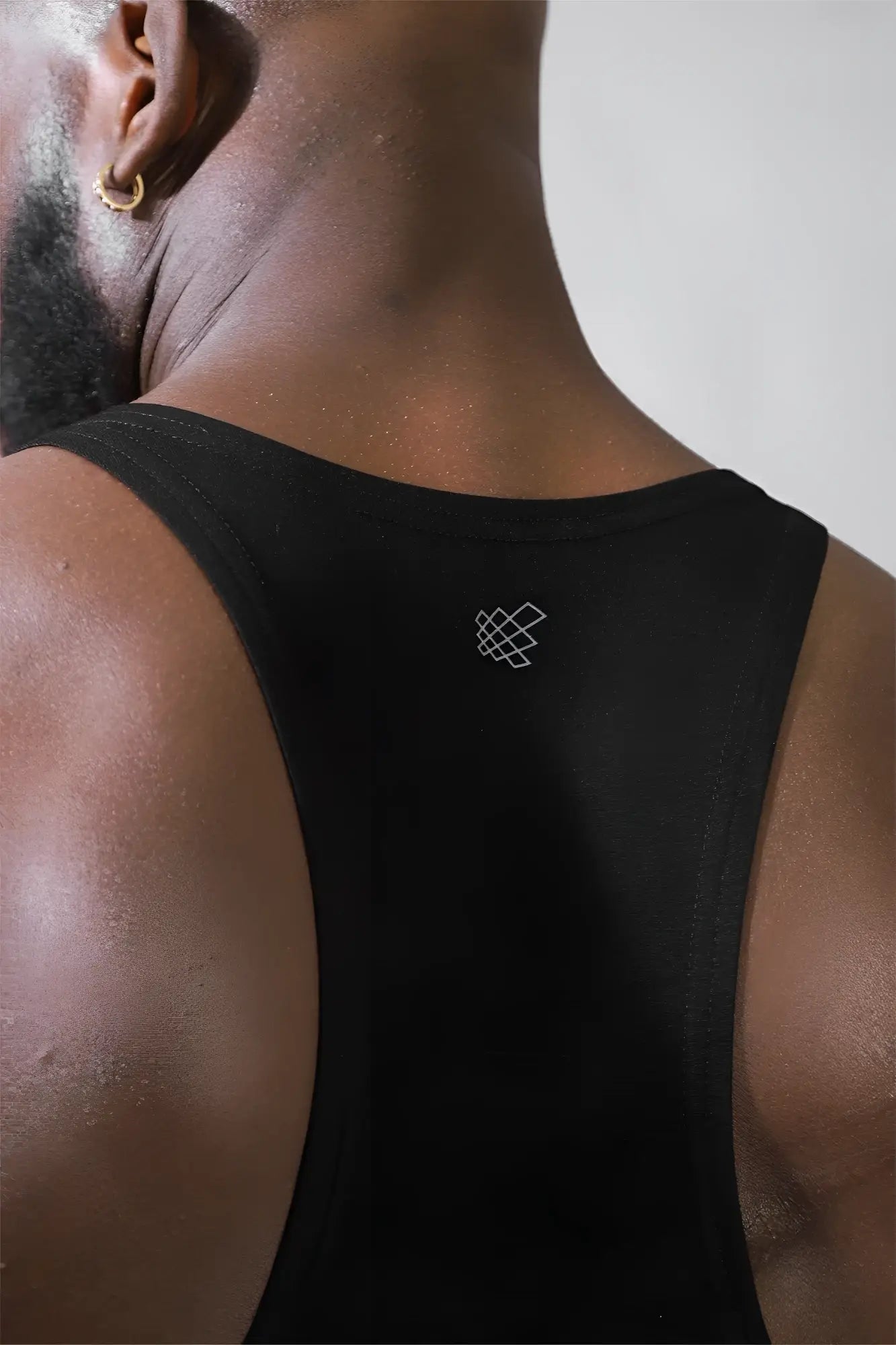 Back view of jed north classic bodybuilding racerback stringer premium black athletic tank top with white logo
