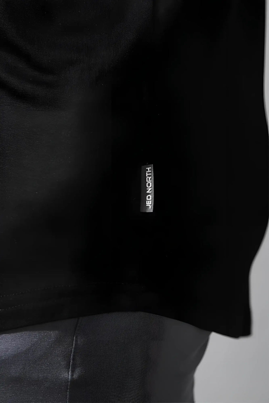 Black cotton jed north classic bodybuilding racerback stringer t-shirt with vertical brand tag near hem